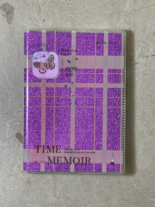 Purple checkered notebook with 'Time Memoir' text on a textured surface