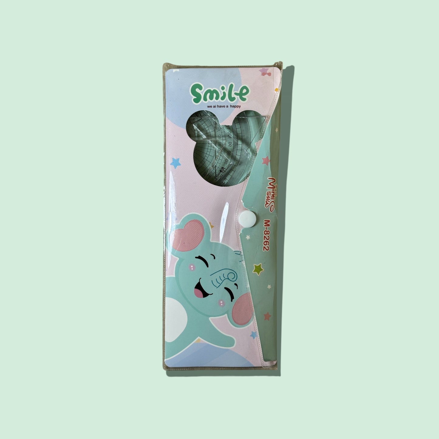 Green toy with a cartoon elephant design on a light green background