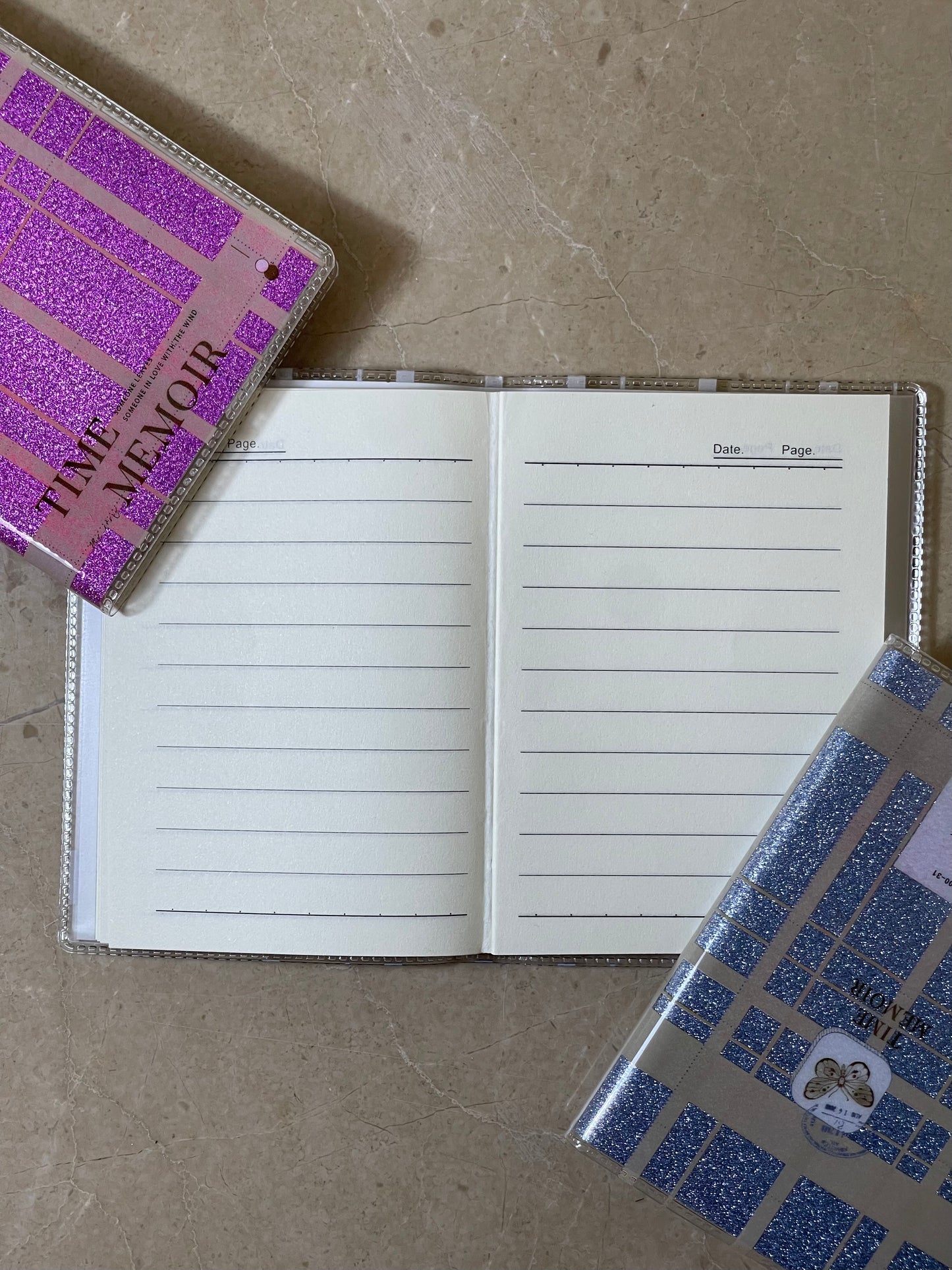 Open notebook with lined pages on a textured surface, with a purple notebook cover in the background.