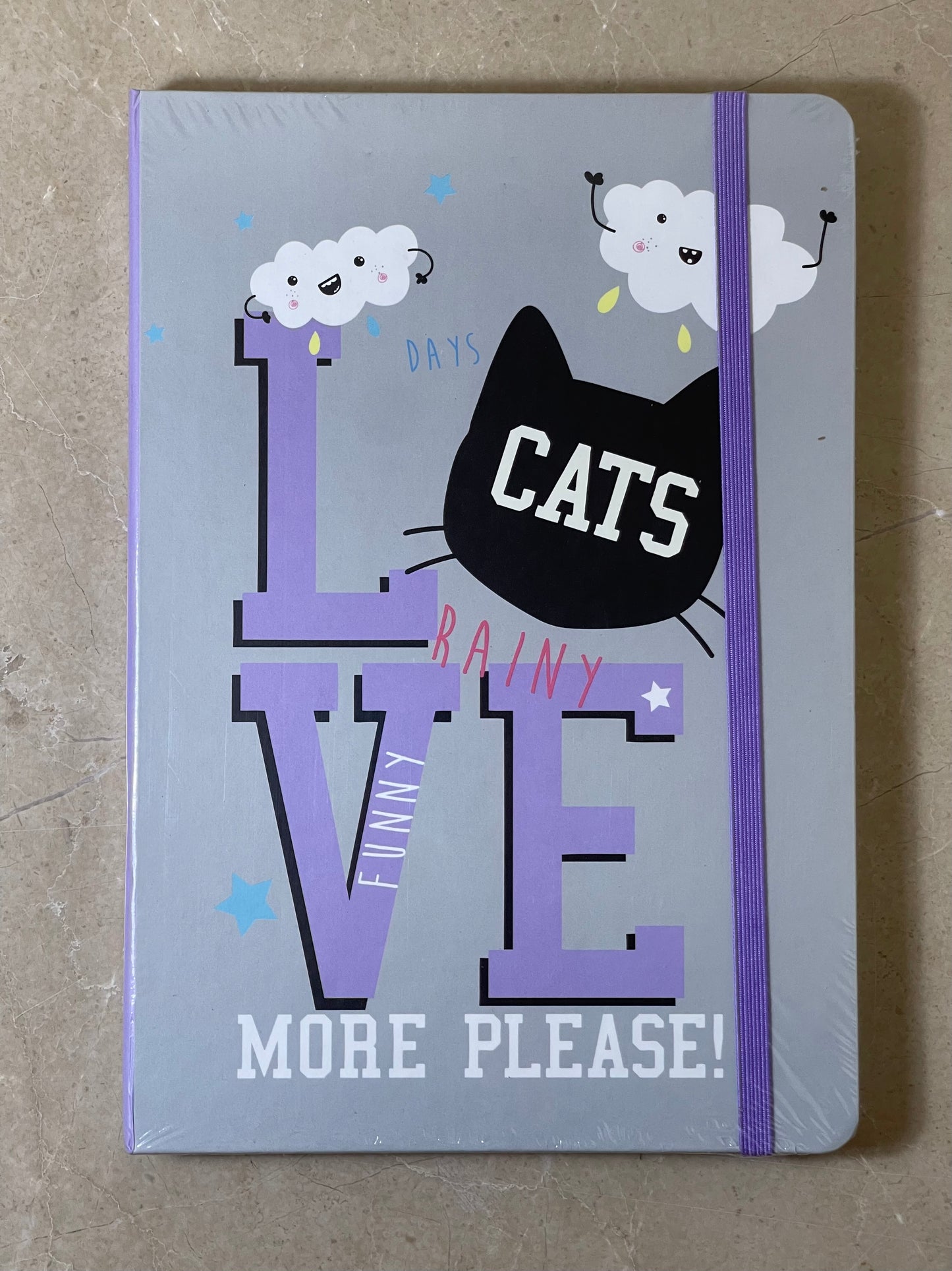 Notebook with a cat-themed design on a gray background