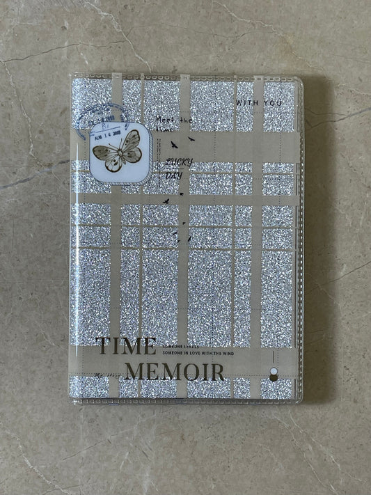 Notebook with decorative cover and 'Time Memoir' text on a textured surface