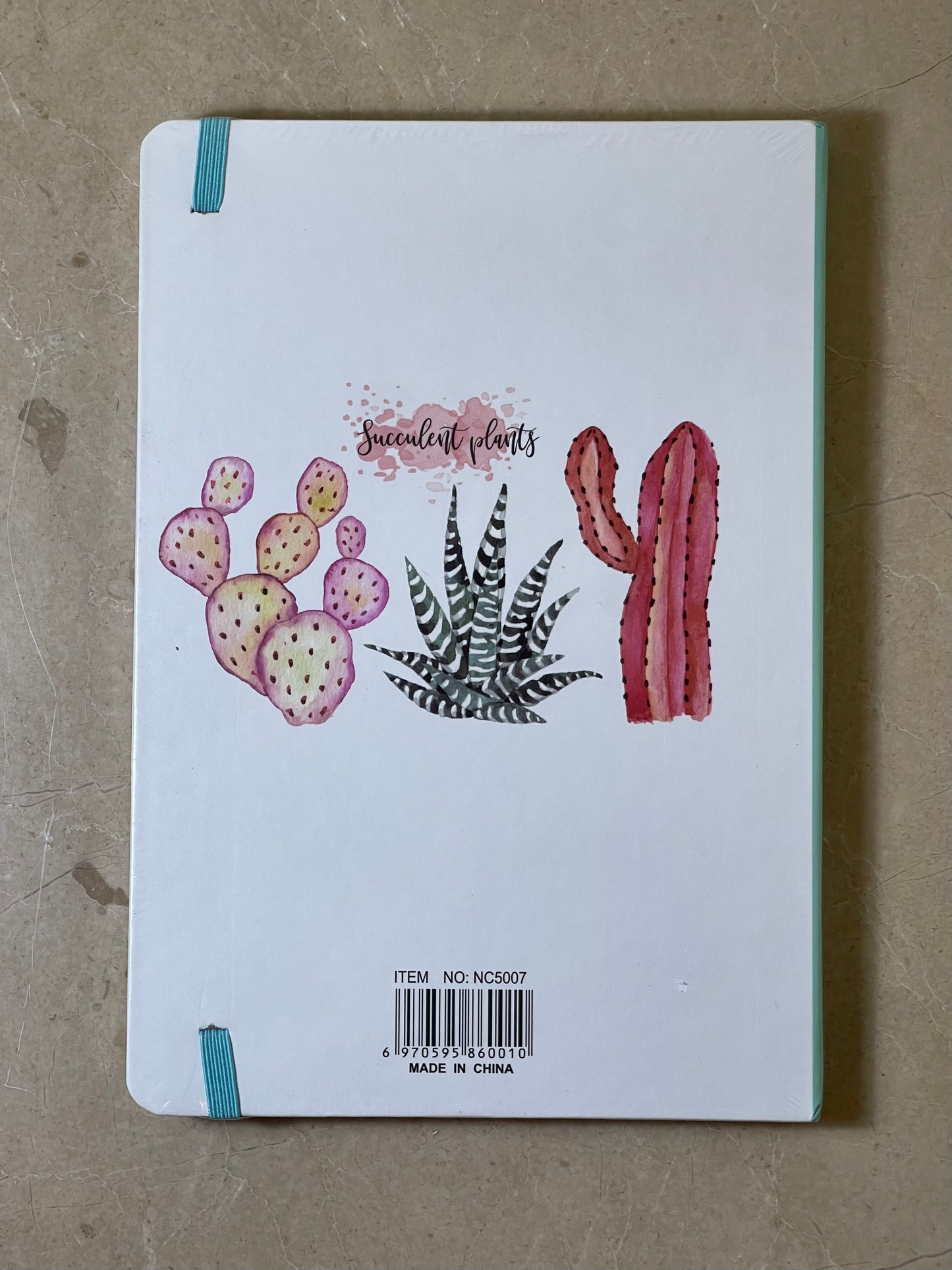 Notebook with succulent plant illustrations on a textured surface