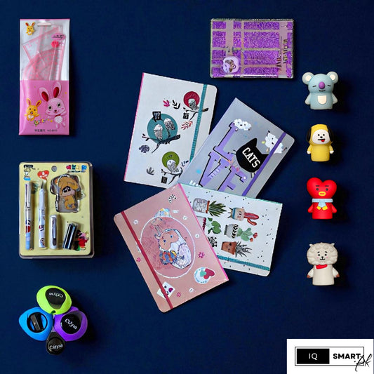 Collection of stationery items including notebooks, pens, and small figurines on a dark blue background.